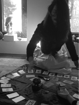 Antoniya laying a wide card spread on a velvet cloth