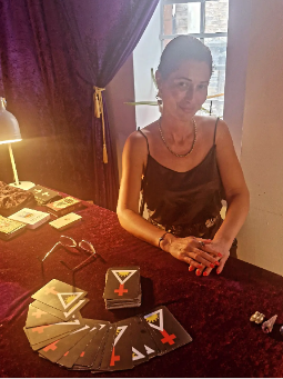 Antoniya at her reading table with cards spread on velvet